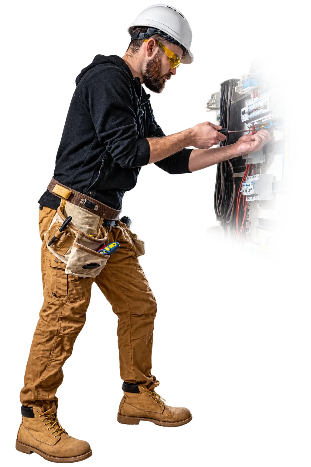 An electrician working inside an open distribution board.